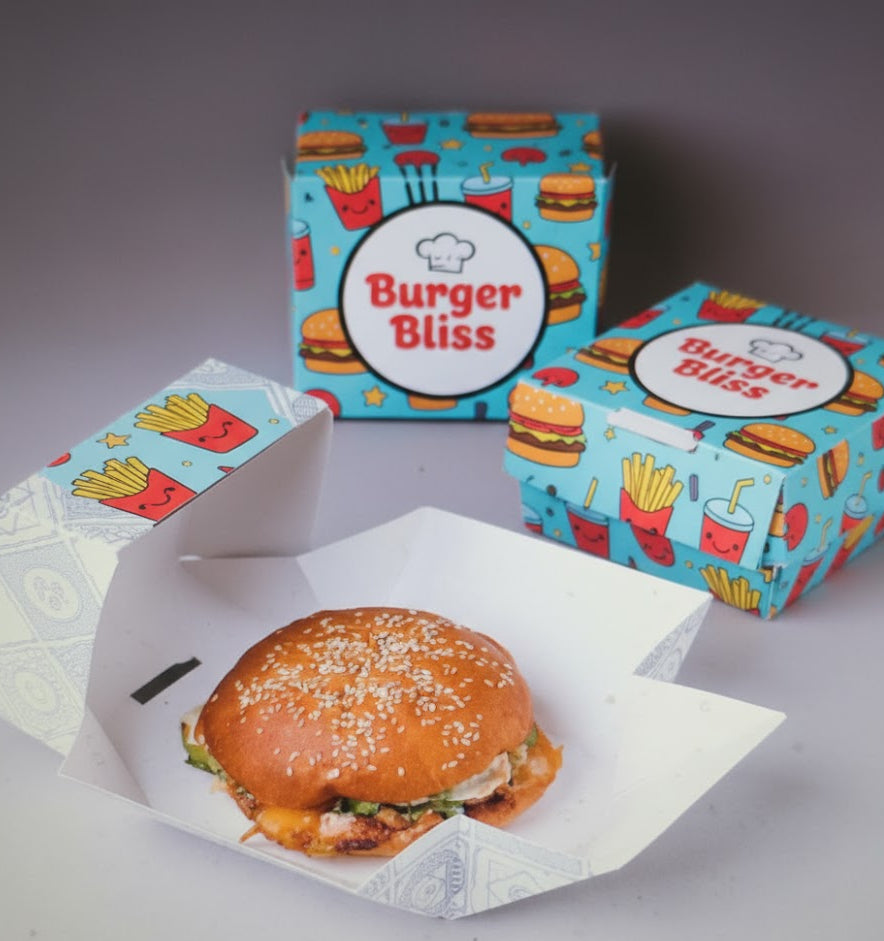 Burger with 'Burger Bliss' boxes on a gray background - Custom Burger boxes, printed burger boxes 